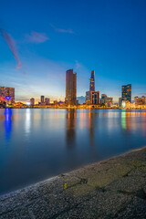 Ho Chi Minh City skyline and the Saigon River at night. Amazing colorful view of skyscraper and other modern buildings. Travel concept