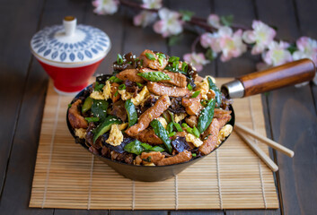 Moo shu pork. Homemade Chinese stir-fry dish made with marinated pork, cucumber, egg scramble,...