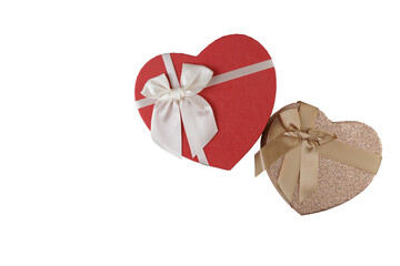 Red and gold heart-shaped boxes with white and gold bows for Valentine's Day, on a white background for gift giving.