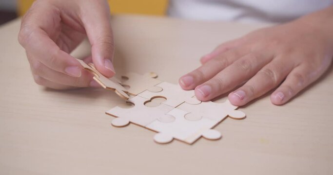Wood Puzzle for teamwork achievement. Playing a jigsaw game. Business success and goal concept.