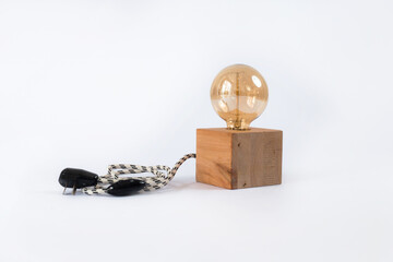 Sphere bulb lighting on a wooden base. Tiny lamp for home deco. Minimalist small lamp.