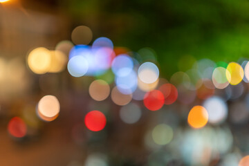 city blurring lights abstract circular bokeh on green background