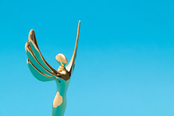 Golden statuette of a woman with wings