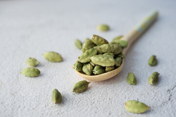 close up of Cardamom on a spoon on table 