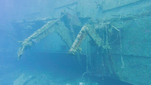 Swimming along outside of large underwater shipwreck