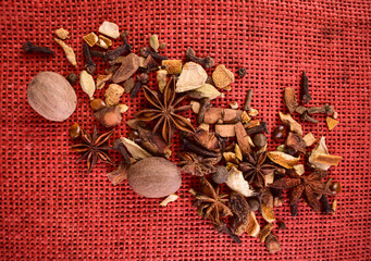 Spices for cooking mulled wine on a red background.Flet ley.  © Olivka888