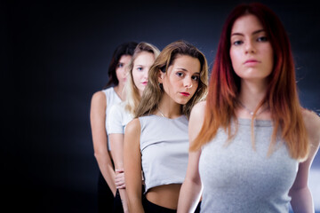 Group of teenage girls on a studio photoshoot. Young women photoshoot for model agency. Young female fashion models.