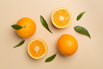 Flat lay with fresh oranges and leaves on color background