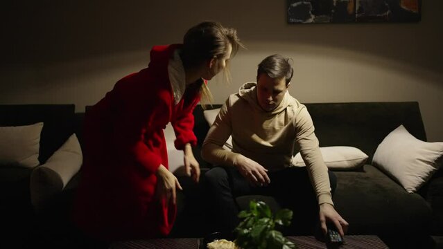 The woman brought her husband dinner into the living room