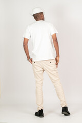Back side of an african man with blank white shirt doing a pose with white background