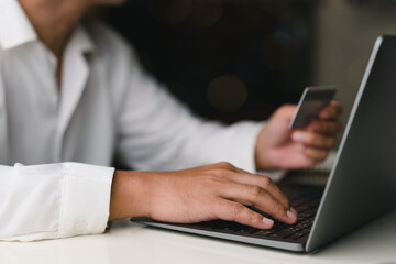 Businessman hold credit  Shopping Online on virtual screen and find products on sale. Concept shopping, e-commerce, internet banking, spending money, purchase product,cheap products sale.