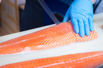 Japanese chefs filleting salmon, a delicate professional skill to make the most of the fillets.