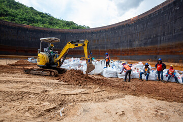 Group of worker and construction engineer excavation at bottom tank oil