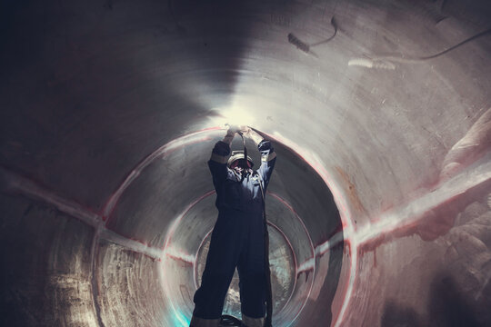 Welding  arc argon worker male repaired metal is welding sparks industrial construction tank stainless