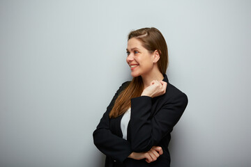 Smiling business woman in black suit looking at left side isolated profile portrait.