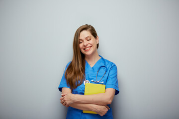 Happy woman medical student with book. Doctor or nurse looking down. Isolated female portrait.