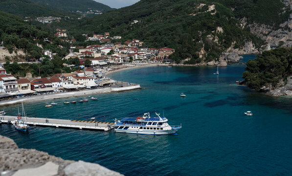 Parga town, Greece: 01 june 2022 - beautiful harbour among mountains , tourictic beach town, yachts on anchor, popular travel destination