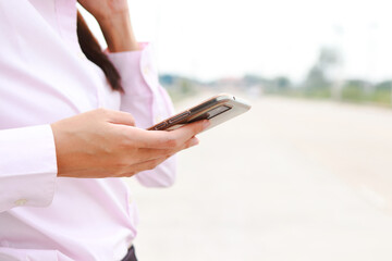 Woman holding smartphone informs car insurance company for help. Transportation concept. car accident insurance