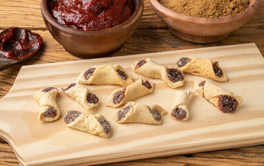 Goiabinha or beliscao, traditional brazilian homemade guava filled biscuit over wooden table
