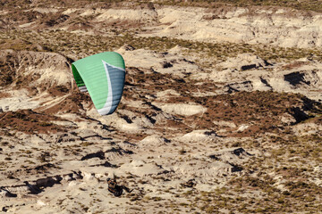 Paragliding above desert area in the badlands