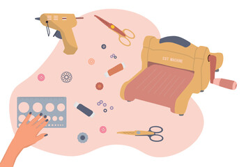 Scrapbooking tools. Cutting machine, ruler, threads, scissors with hand
