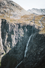 Fototapeta na wymiar Waterfall with mountains in moody autumn Norway.