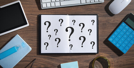 Question marks on notepad. Business concept