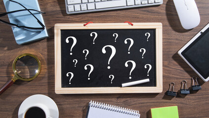 Question marks on blackboard. Business concept
