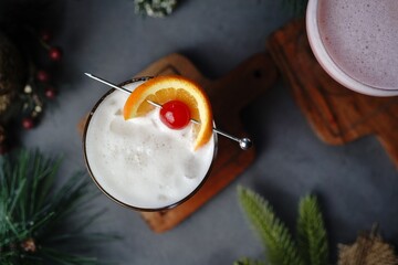 New year cocktail Whisky Sour on festive holiday bokeh background