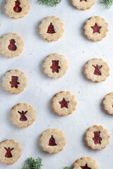 Christmas cookies, Linzer cookies on the light background, different motifs.
