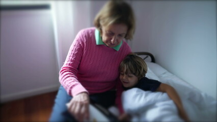 Grandmother reading a book to grandchild. Candid grandparent tells a bedtime story to toddler boy child