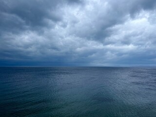 Cloudy sea view, dark clouds at the sea, rocky coast