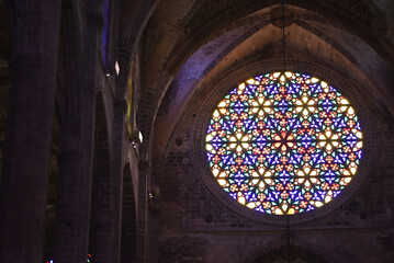 Palma, Mallorca, Spain - 10 Nov 2022: Colourful stained glass Rose Window in Palma Cathedral