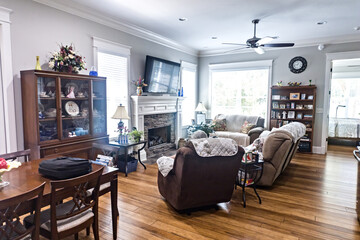 A traditional living roomwith a fireplace, hardwood floors and comfortable loveseat and armchair