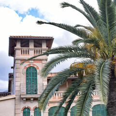 Fototapeta na wymiar Soller, Mallorca, Spain - 11 Nov 2022: Historic buildings and palm trees on the holiday island of Mallorca