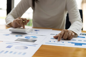 Accountant working on consolidated financial report of corporate operations, consultant auditing...