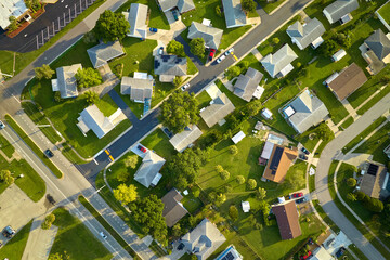 Aerial view of small town America suburban landscape with private homes between green palm trees in Florida quiet residential area - obrazy, fototapety, plakaty