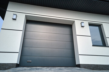 Automatic electric roll-up commercial garage gate or push-up door in modern private building ground...