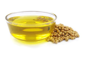 Glass bowl with cooking oil and heap of soybeans isolated on white background