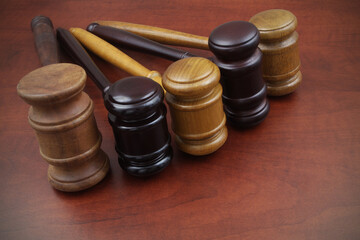 Close up of different judge gavel on wooden table. Different laws, courts and legal systems concept.