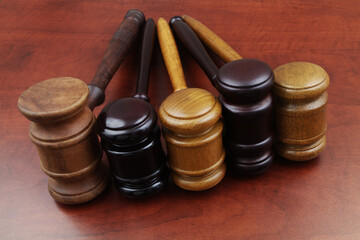 Close up of different judge gavel on wooden table. Different laws, courts and legal systems concept.