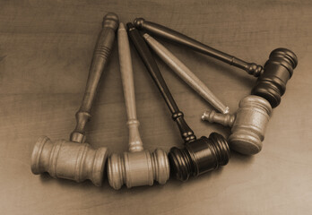 Many wooden judge gavels on table, one judge gavel broken. Symbol corruption and bribes in legal...