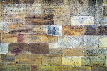 Multicoloured stone sea wall in Yorkshire
