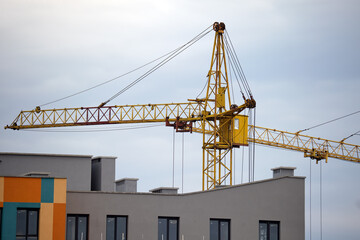 Tower cranes at high residential apartment buildings construction site. Real estate development