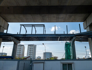 The unfinished metal frame of the sky walks bridge.