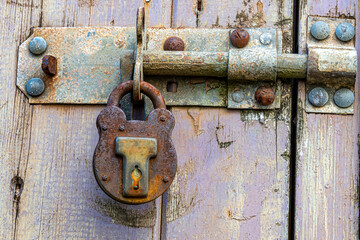 old padlock on a rotten door