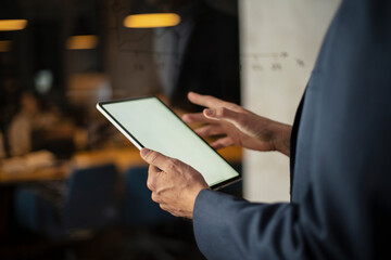 Close up of man using digital tablet.
