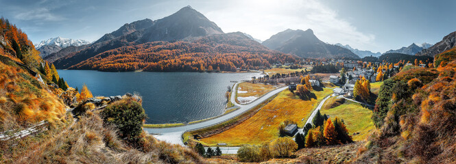 Amazing natural autumn scenery.  Panoramic view of beautiful mountain valley in Alps with Lake Sils, concept of an ideal resting place. Lake Sils one of the most beautiful lake of the Swiss Alps