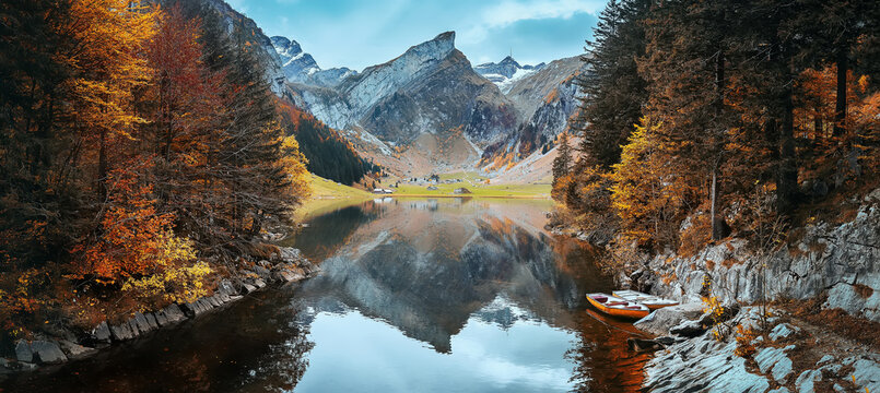 Amazing autumn scenery of Swiss Alps. Incredible nature landscape. View on Santis peak, Seealpsee lake and colorful trees in autumn time. Awesome nature Background. Concept ideal resting place