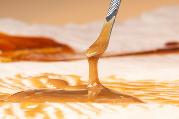 extract cannabis hash rosin closeup on paper, dab tool